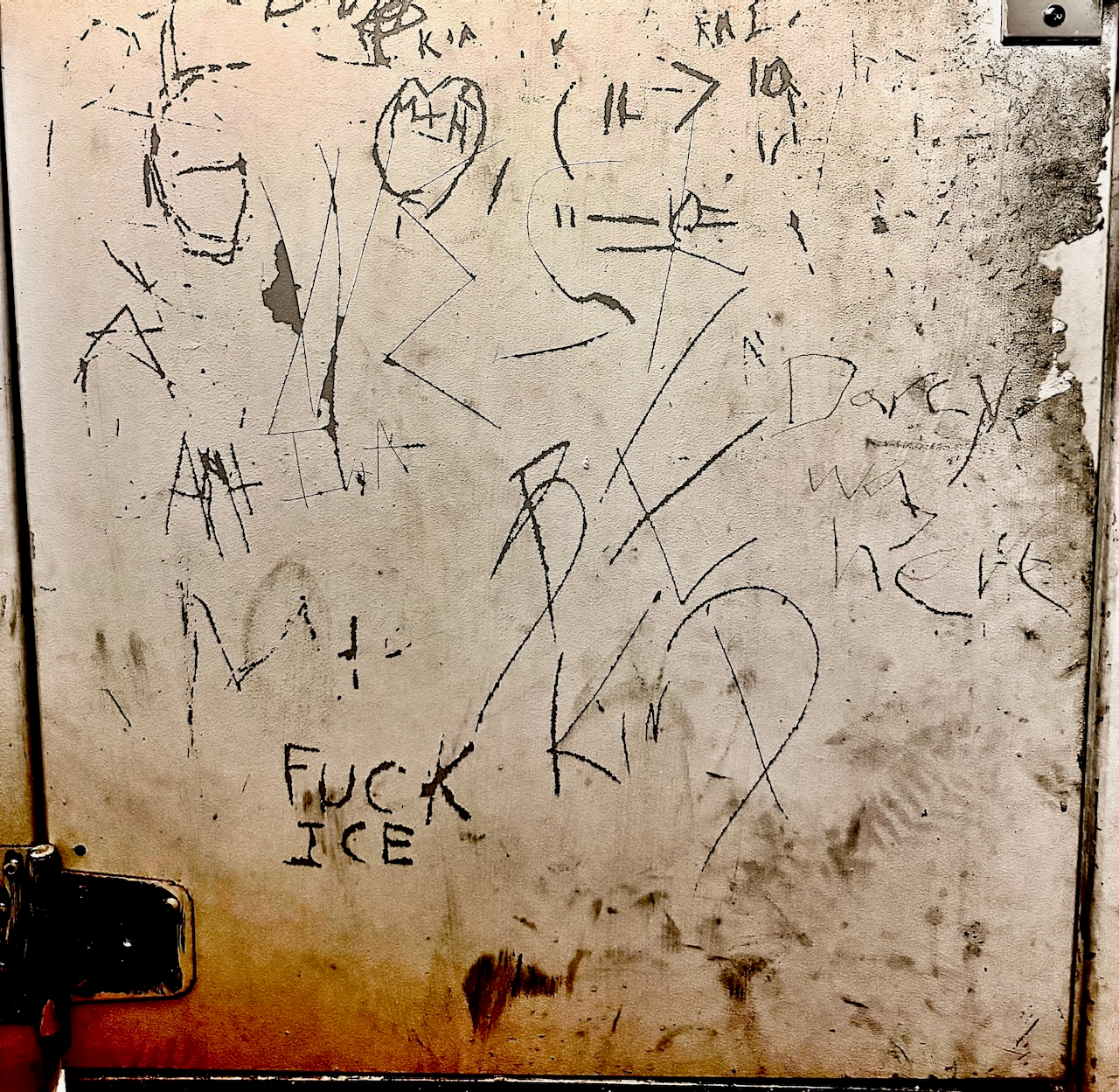 Bathroom stall door with lots of text, including "Fuck ICE" and "Be Kind."