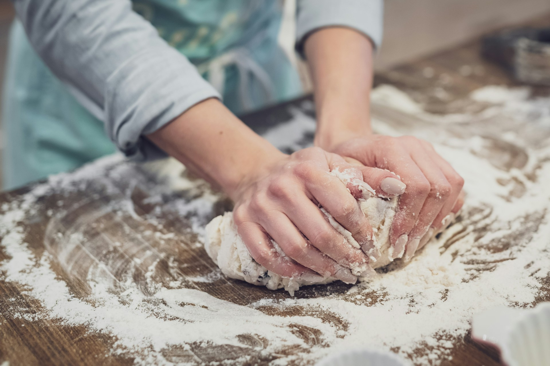 a person's hands kneading dough