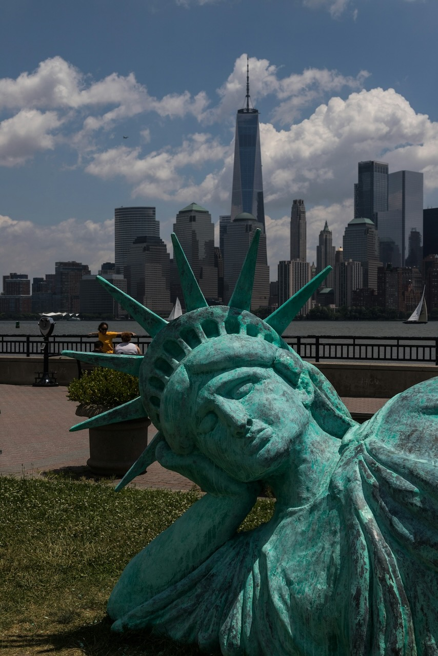 Statue of Liberty without her torch, reclining in a park